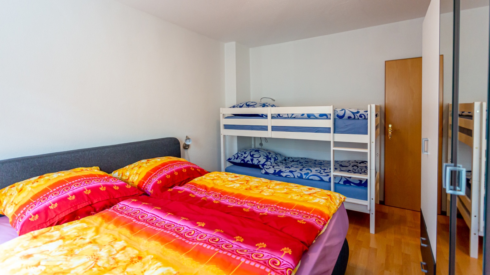 Schlafzimmer der Ferienwohnung 2 mit Boxspringbett und Doppelstockbett